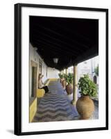 Tourist on Terrace with Striped Cobblestone Floor and Planters, Portugal-Merrill Images-Framed Photographic Print