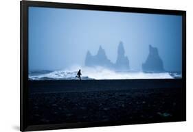 Tourist running on Black Sand Beach, Iceland, Polar Regions-John Alexander-Framed Photographic Print