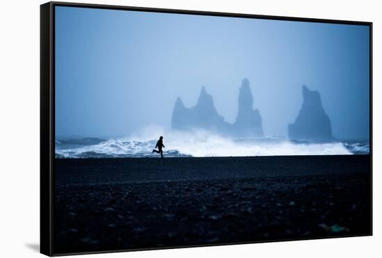 Tourist running on Black Sand Beach, Iceland, Polar Regions-John Alexander-Framed Stretched Canvas