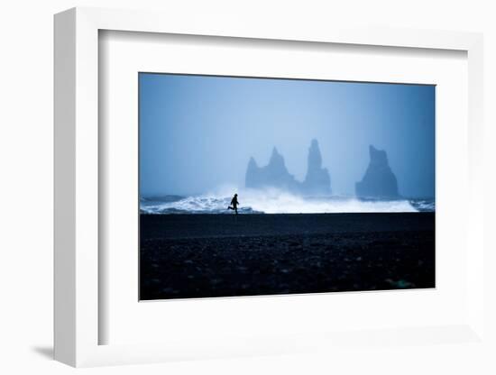 Tourist running on Black Sand Beach, Iceland, Polar Regions-John Alexander-Framed Photographic Print