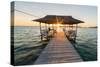 Tourist Sitting on Wooden Jetty While Watching a Stunning Sunrise on the Sea. Togean (Or Togian) Is-Fabio Lamanna-Stretched Canvas