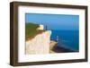 Tourist stands on top of the cliff overlooking Beachy Head lighthouse, Seven Sisters chalk cliffs-Paolo Graziosi-Framed Photographic Print
