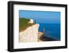 Tourist stands on top of the cliff overlooking Beachy Head lighthouse, Seven Sisters chalk cliffs-Paolo Graziosi-Framed Photographic Print