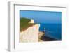 Tourist stands on top of the cliff overlooking Beachy Head lighthouse, Seven Sisters chalk cliffs-Paolo Graziosi-Framed Photographic Print