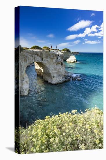 Tourists admiring the sea from natural stone arch on cliff, Torre Sant'Andrea-Roberto Moiola-Stretched Canvas