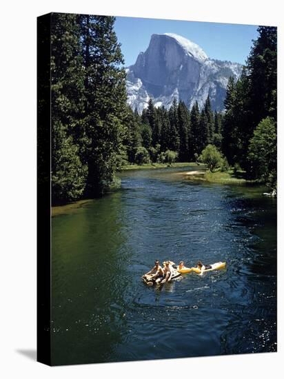 Tourists Float on a Raft in the Merced River at Yosemite National Park-Ralph Crane-Stretched Canvas