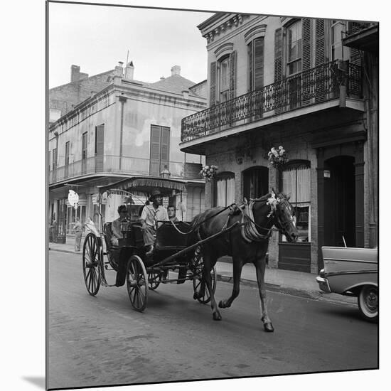 Tourists Take in the Scenery Via Horse-Drawn Carriage on Royal Street in New Orleans-null-Mounted Photographic Print