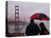 Tourists Use an Umbrella During a Light Rain, Looking at the Golden Gate Bridge in San Francisco-null-Stretched Canvas