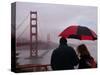 Tourists Use an Umbrella During a Light Rain, Looking at the Golden Gate Bridge in San Francisco-null-Stretched Canvas