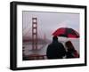 Tourists Use an Umbrella During a Light Rain, Looking at the Golden Gate Bridge in San Francisco-null-Framed Photographic Print