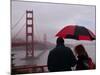 Tourists Use an Umbrella During a Light Rain, Looking at the Golden Gate Bridge in San Francisco-null-Mounted Photographic Print