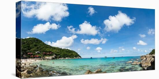 Toursits enjoy the clear water and sun at a beach on the Thai island of Koh Tao, Thailand-Logan Brown-Stretched Canvas