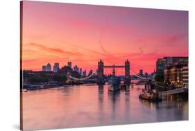 Tower Bridge, River Thames and HMS Belfast at sunrise with pink sky, and Canary Wharf-Ed Hasler-Stretched Canvas