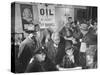 Town Residents Standing in Gas Station, Discussing Problems Caused by Oil Boom-Bernard Hoffman-Stretched Canvas