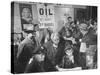 Town Residents Standing in Gas Station, Discussing Problems Caused by Oil Boom-Bernard Hoffman-Stretched Canvas