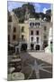 Town Square with Restaurant Tables and Colourful Buildings-Eleanor Scriven-Mounted Photographic Print