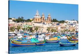 Traditional brightly painted fishing boats in the harbour at Marsaxlokk, Malta, Mediterranean, Euro-Martin Child-Stretched Canvas