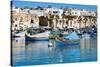 Traditional brightly painted fishing boats in the harbour at Marsaxlokk, Malta, Mediterranean, Euro-Martin Child-Stretched Canvas
