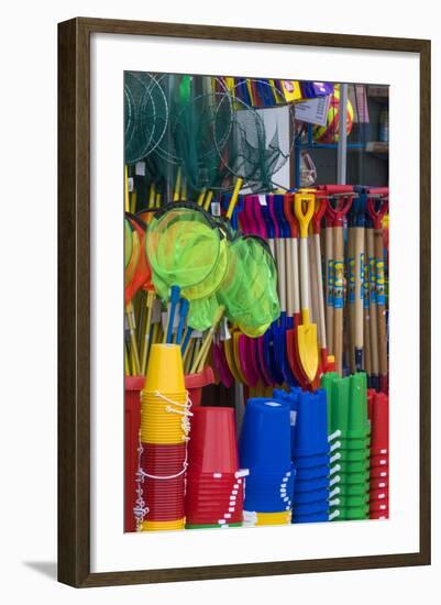 Traditional Buckets and Spades on Sale in a Seaside Shop in Lyme Regis-John Woodworth-Framed Photographic Print