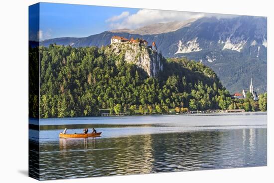 Traditional wooden pletnja rowing boat to ferry tourists to St. Mary's Church of Assumption on the-Miva Stock-Stretched Canvas