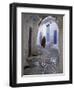 Traditionally Dressed Woman along Cobblestone Alley, Morocco-Merrill Images-Framed Photographic Print