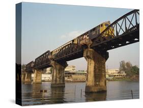 Train Crossing the River Kwai Bridge at Kanchanburi in Thailand, Southeast Asia-Charcrit Boonsom-Stretched Canvas
