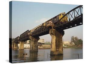 Train Crossing the River Kwai Bridge at Kanchanburi in Thailand, Southeast Asia-Charcrit Boonsom-Stretched Canvas