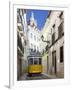 Tram (Electricos) Along Rua Das Escolas Gerais with Tower of Sao Vicente de Fora, Lisbon, Portugal-Stuart Black-Framed Photographic Print