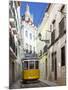 Tram (Electricos) Along Rua Das Escolas Gerais with Tower of Sao Vicente de Fora, Lisbon, Portugal-Stuart Black-Mounted Photographic Print