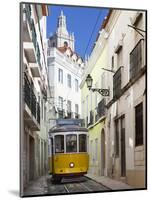 Tram (Electricos) Along Rua Das Escolas Gerais with Tower of Sao Vicente de Fora, Lisbon, Portugal-Stuart Black-Mounted Photographic Print