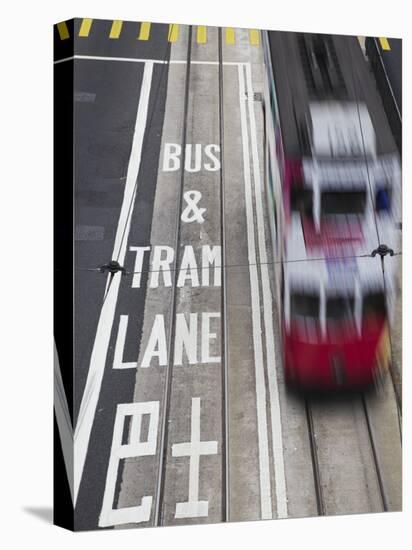 Tram Passing Along Des Voeux Road Central, Central, Hong Kong, China-Ian Trower-Stretched Canvas