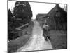 Tramp Named John Walpole Walking in Village Carrying Bag over His Shoulder-null-Mounted Photographic Print