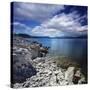 Tranquil Lake and Rocky Shore Against Cloudy Sky, Sardinia, Italy-null-Stretched Canvas