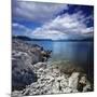 Tranquil Lake and Rocky Shore Against Cloudy Sky, Sardinia, Italy-null-Mounted Photographic Print