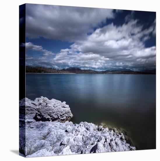 Tranquil Lake and Rocky Shore Against Cloudy Sky, Sardinia, Italy-null-Stretched Canvas