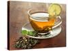 Transparent Cup of Green Tea with Lime on Wooden Background-Yastremska-Stretched Canvas