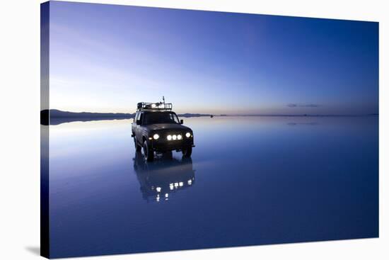 Travelers Drive their Suv across a the Salar De Uyuni, a Flooded Salt Flat, in Bolivia-Sergio Ballivian-Stretched Canvas