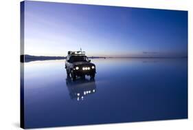 Travelers Drive their Suv across a the Salar De Uyuni, a Flooded Salt Flat, in Bolivia-Sergio Ballivian-Stretched Canvas