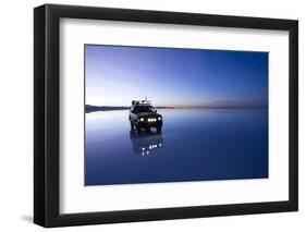 Travelers Drive their Suv across a the Salar De Uyuni, a Flooded Salt Flat, in Bolivia-Sergio Ballivian-Framed Photographic Print