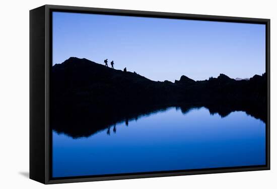 Trekkers are Reflected in the Cool Waters of Chilata Lagoon Outside the Town of Sorata, Bolivia-Sergio Ballivian-Framed Stretched Canvas