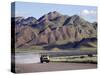 Truck Passing Through the Naukluft Mountains Near Solitaire, Namibia-Julian Love-Stretched Canvas