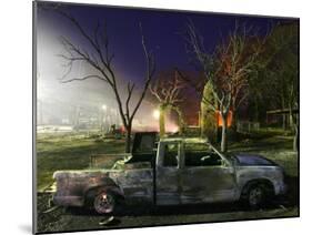 Truck Remnants in Front of a House Still Smoldering from a Grass Fire in a Small Town in Texas-null-Mounted Photographic Print