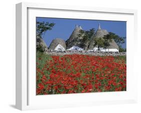 Trulli houses with red poppy field in foreground, near Alberobello, Apulia, Italy, Europe-Stuart Black-Framed Premium Photographic Print