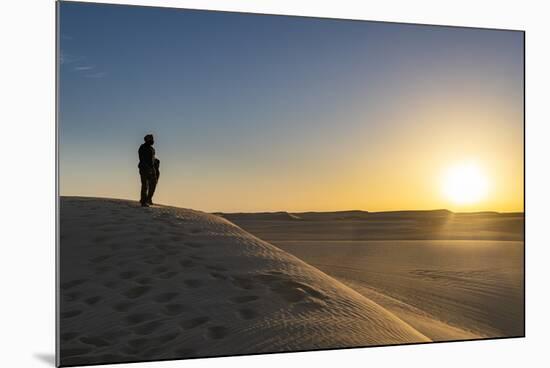 Tuareg standing on a sand dune in the Tenere Desert at sunrise, Sahara, Niger, Africa-Michael Runkel-Mounted Photographic Print