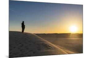 Tuareg standing on a sand dune in the Tenere Desert at sunrise, Sahara, Niger, Africa-Michael Runkel-Mounted Photographic Print