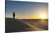Tuareg standing on a sand dune in the Tenere Desert at sunrise, Sahara, Niger, Africa-Michael Runkel-Stretched Canvas