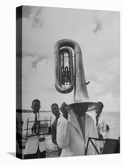 Tuba Player Keeping His Head Dry in a Rainstorm During Visit to St. Croix by Pres. Harry S. Truman-Thomas D^ Mcavoy-Stretched Canvas