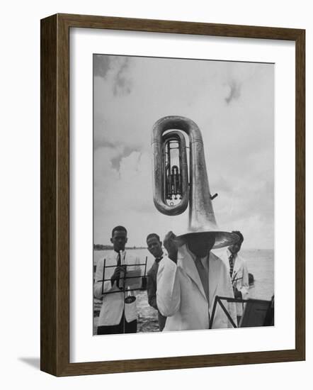 Tuba Player Keeping His Head Dry in a Rainstorm During Visit to St. Croix by Pres. Harry S. Truman-Thomas D^ Mcavoy-Framed Photographic Print