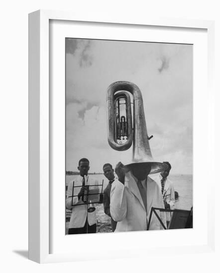 Tuba Player Keeping His Head Dry in a Rainstorm During Visit to St. Croix by Pres. Harry S. Truman-Thomas D^ Mcavoy-Framed Photographic Print