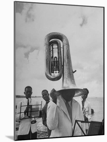 Tuba Player Keeping His Head Dry in a Rainstorm During Visit to St. Croix by Pres. Harry S. Truman-Thomas D^ Mcavoy-Mounted Photographic Print